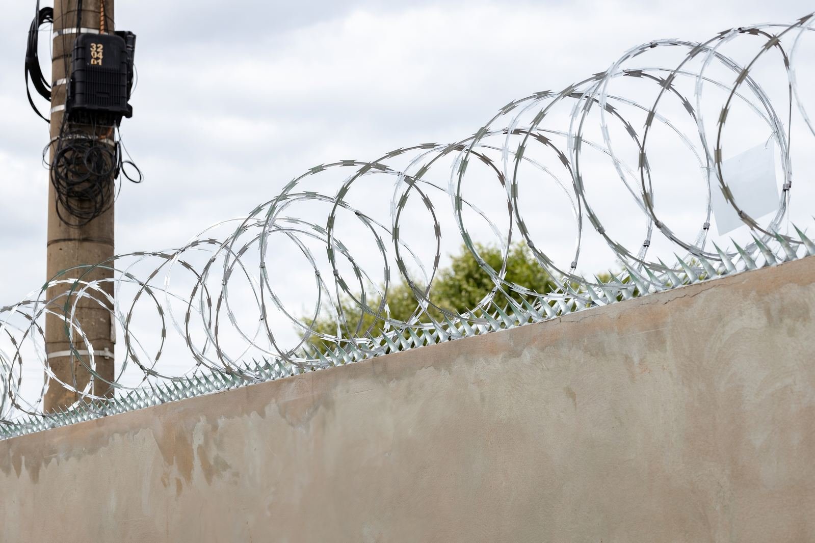 Concertina coil wire along a boundary wall